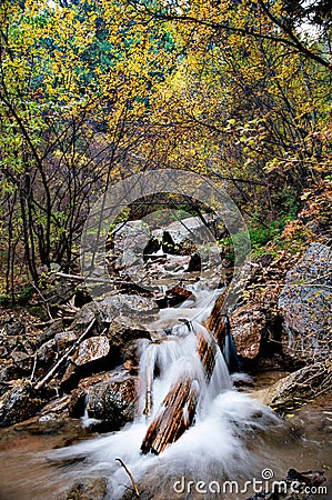 Stunning waterfall cascading down a rocky outcrop in the Seven Bridges Trail of Colorado Springs Stock Photo