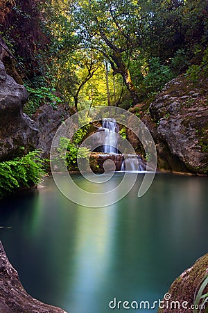 Stunning waterfall with an emerald pond in deep green forest in Manavgat, Antalya, Turkey Stock Photo