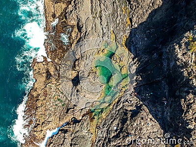 Stunning wide angle aerial drone view of the Mermaid Rock Pools and ocean waves at Matapouri Bay near Whangarei on the North Islan Stock Photo