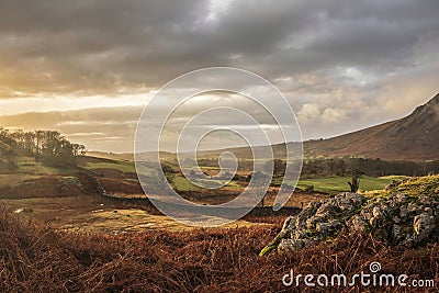 Stunning Winter sunset golden hour landscape image of view from Wast Water over countryside in Lake District towards the Western Stock Photo