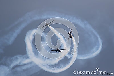 Stunt planes, weaving about with white smoke Stock Photo