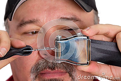 Stupid dim-witted man unable to fasten a seatbelt Stock Photo