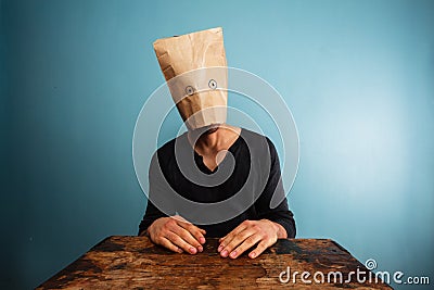 Stupid man with bag over his head Stock Photo