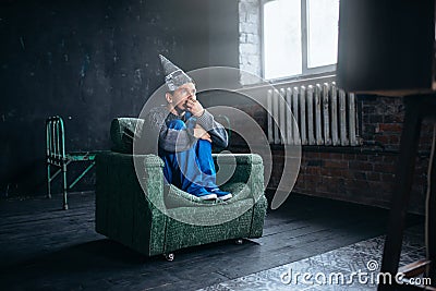 Stupid man in tinfoil helmet watch TV, UFO phobia Stock Photo