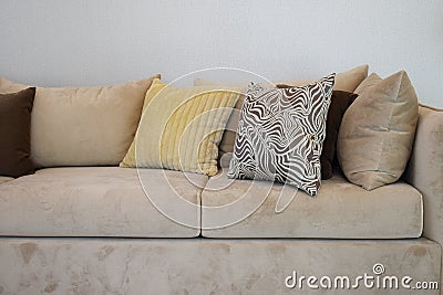Sturdy brown tweed sofa with grey patterned pillows Stock Photo