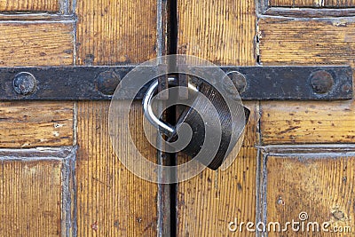 Sturdy padlock on polished wood door Stock Photo