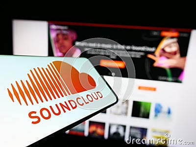 Mobile phone with logo of German music sharing company SoundCloud on screen in front of business website. Editorial Stock Photo