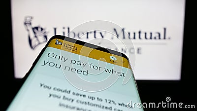 Mobile phone with web page of American insurance company Liberty Mutual Group on screen in front of logo. Editorial Stock Photo