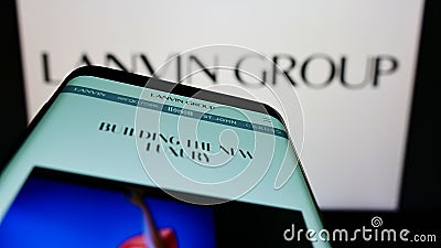 Mobile phone with website of Chinese fashion company Lanvin Group on screen in front of business logo. Editorial Stock Photo