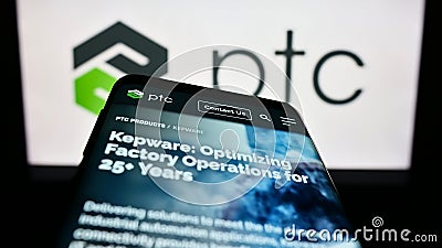 Mobile phone with website of US software company PTC Inc. on screen in front of business logo. Editorial Stock Photo