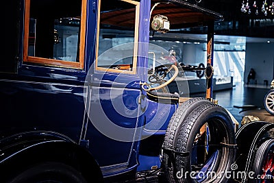 STUTTGART, GERMANY - OCTOBER 16, 2018: Mercedes Museum. Classic blue old vehicle. Side view. Spare wheels on the side Editorial Stock Photo