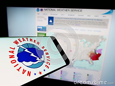 Smartphone with logo of American agency National Weather Service (NWS) on screen in front of website. Editorial Stock Photo