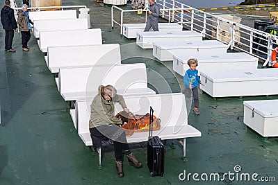 Stykkisholmur, Iceland - July 2, 2023: Ferry Baldur passengers sit on benches on the boat to sail to Flatey Island and the Editorial Stock Photo