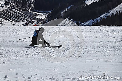 Style carving. A male skier training on competition in downhill. Carve position. Black and blue jacket. Chopok, Low Tatras, Stock Photo