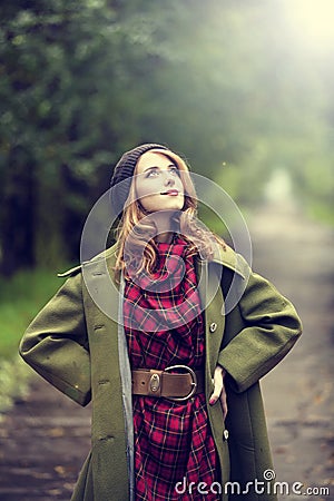 Style redhead girl at beautiful autumn alley. Stock Photo