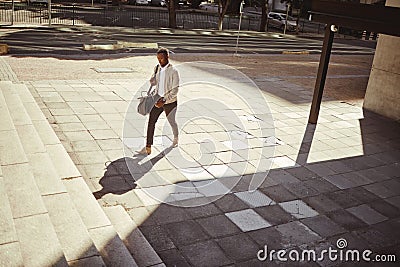 Style, travel and a fashion young man walking in a empty city or urban town. Corporate african american man or business Stock Photo