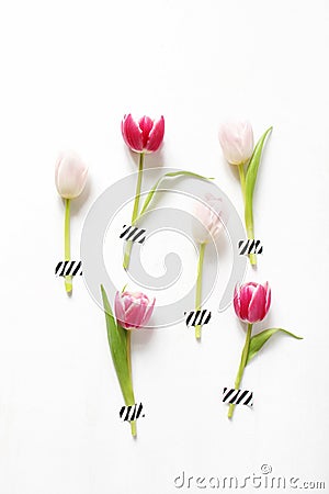 Styled stock photo. Feminine Easter, spring composition with pink tulips taped on white background. Floral pattern. Flat Stock Photo