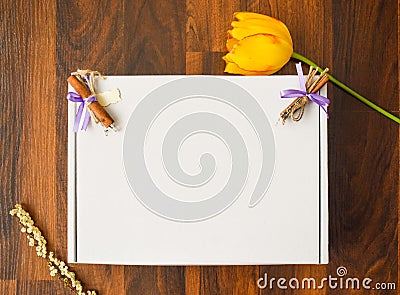 Styled Stock Photography Mockup Digital File. blank cardboard square with wooden floor background with yellow tulip, lily of the Stock Photo