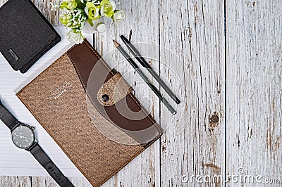 Styled tabletop, whitewood workspace, brown notebook and office objects, work desk top view with work utensils Stock Photo