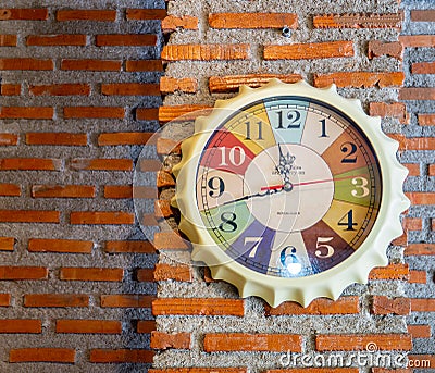 Stylish analog clock hanging on brick wall Editorial Stock Photo