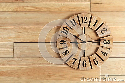 Stylish analog clock hanging on wooden wall Stock Photo