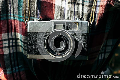 Stylish analog photo camera on traveler in sunny forest in the m Stock Photo