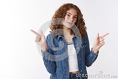 Stylish attractive cool urban college girl freckles pimples redheaded, pointing left right sideways different sides Stock Photo