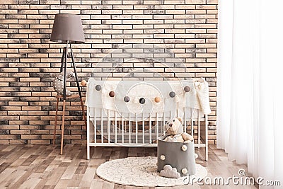 Stylish baby room interior with crib Stock Photo