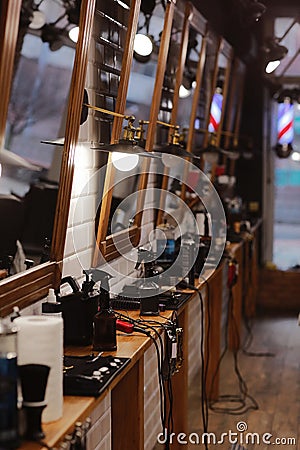 stylish barbershop with places for hairdresser artists, mirrors with illumination, work barber tools, razor, electric Stock Photo