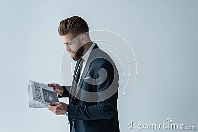 Stylish bearded businessman reading newspaper Stock Photo