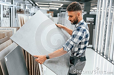 Stylish beautiul man is in the store of goods for the home Stock Photo