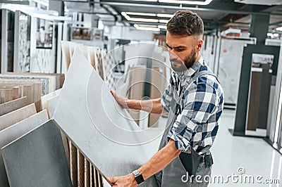 Stylish beautiul man is in the store of goods for the home Stock Photo
