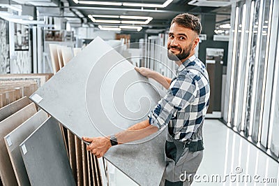 Stylish beautiul man is in the store of goods for the home Stock Photo