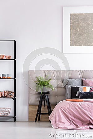 Stylish bedroom with black stool Stock Photo