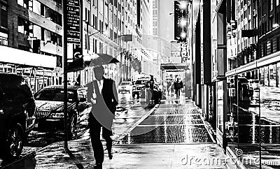 Stylish black and white wet New York NYC commuter with umbrella Stock Photo