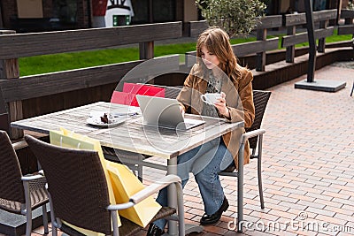 Stylish blogger holding cup and using Stock Photo