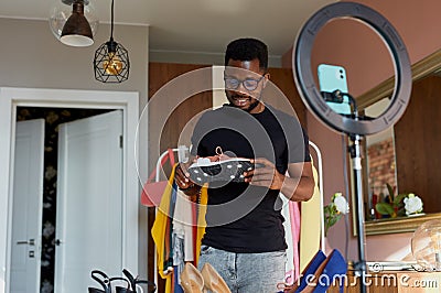 Stylish blogger man checking new sportive sneakers Stock Photo