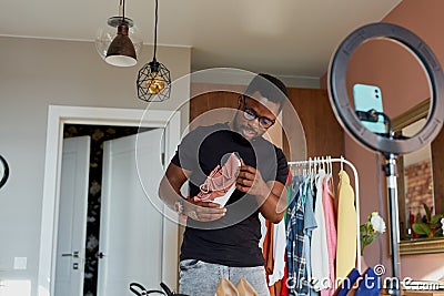 Stylish blogger man checking new sportive sneakers Stock Photo