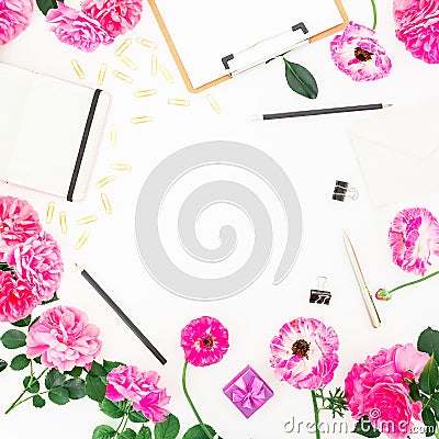 Stylish blogger workspace with clipboard, notebook, pink flowers and accessories on white background. Flat lay, top view. Stock Photo