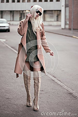 Stylish blonde model walking outdoors Stock Photo