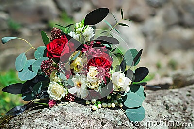 Stylish bouquet with red and white flowers and eucalyptus branches. Unusual wedding bohemian floristic flowers Stock Photo