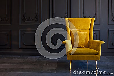 Stylish bright yellow chair against a dark gray wall Stock Photo