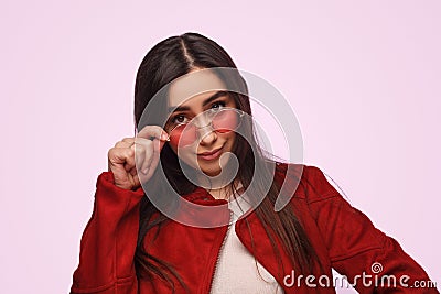 Stylish brunette in red outfit looking confident Stock Photo