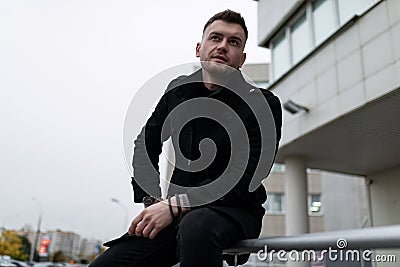 stylish brutal man defiant looking at camera outside Stock Photo