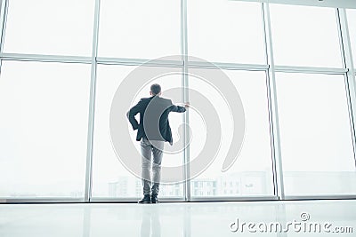 Stylish business man in the background of a large window Stock Photo