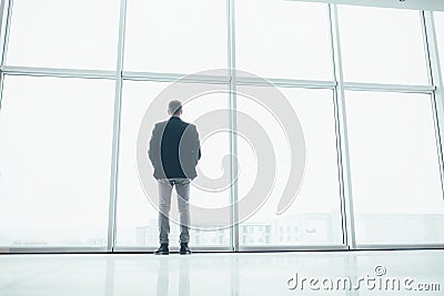 Stylish business man in the background of a large window Stock Photo