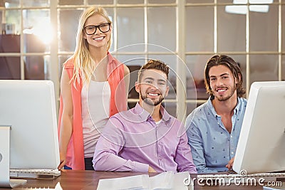 Stylish business people sitting by computer Stock Photo