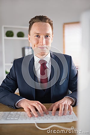 Stylish businessman working at his desk Stock Photo