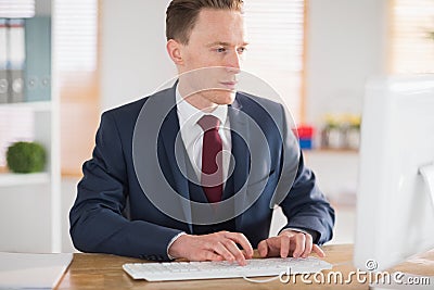 Stylish businessman working at his desk Stock Photo