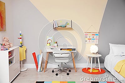 Stylish child room interior with bed and desk Stock Photo